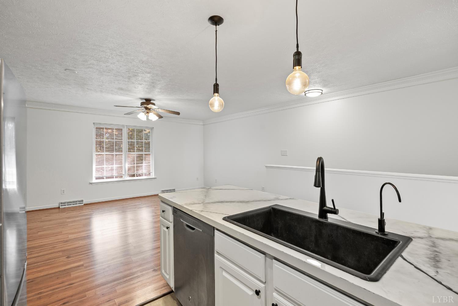 300 McConville Road, Unit 63 Lynchburg, VA 24502 - Photo 12 of 37 a kitchen with stainless steel appliances granite countertop a sink a window and wooden floor