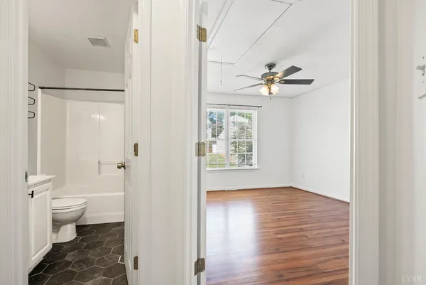a view of a bathroom with a toilet sink a mirror and a shower