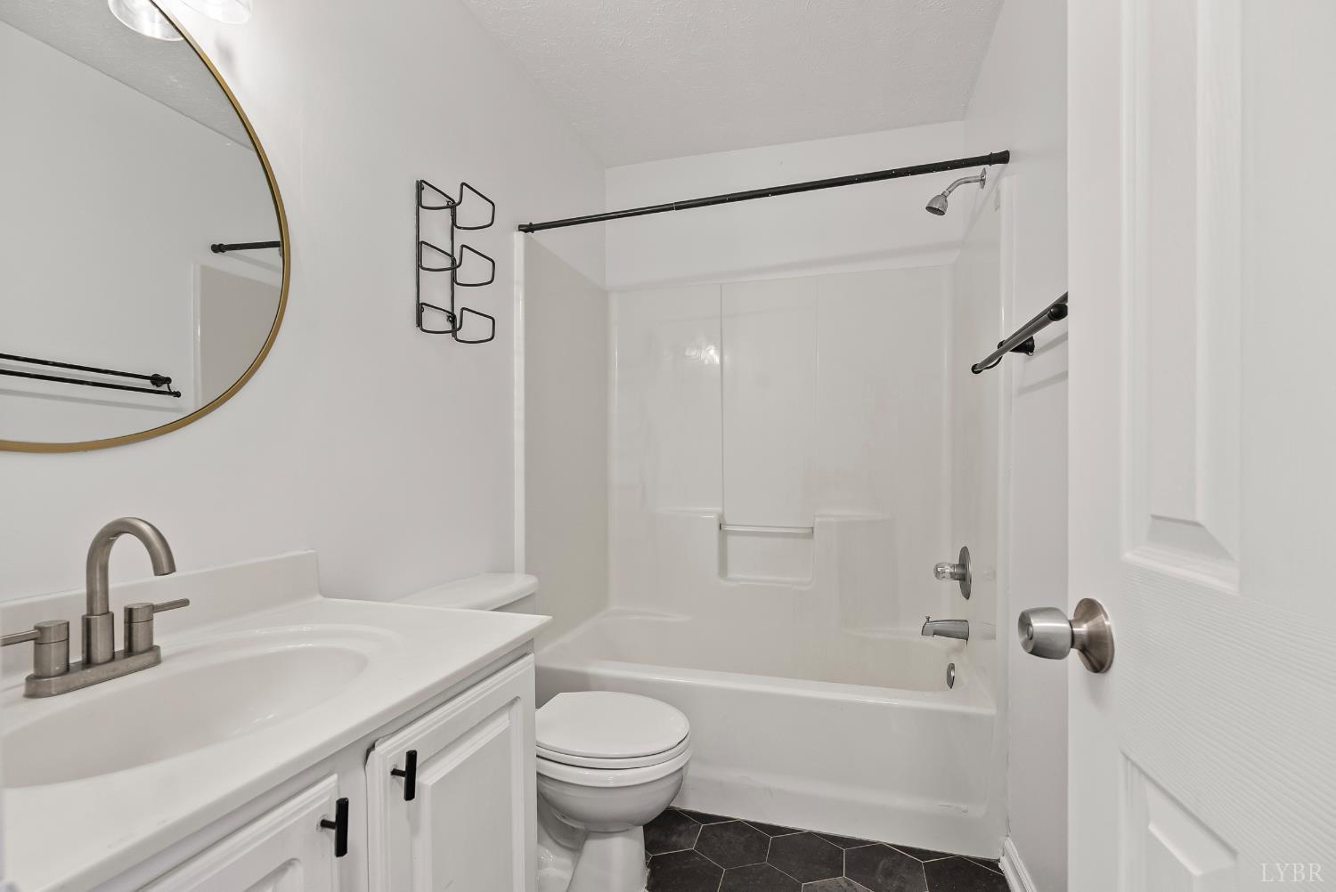 300 McConville Road, Unit 63 Lynchburg, VA 24502 - Photo 19 of 37 a bathroom with a sink a toilet and a bathtub