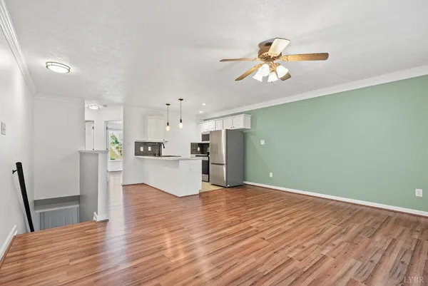 a view of a kitchen with wooden floor and a kitchen