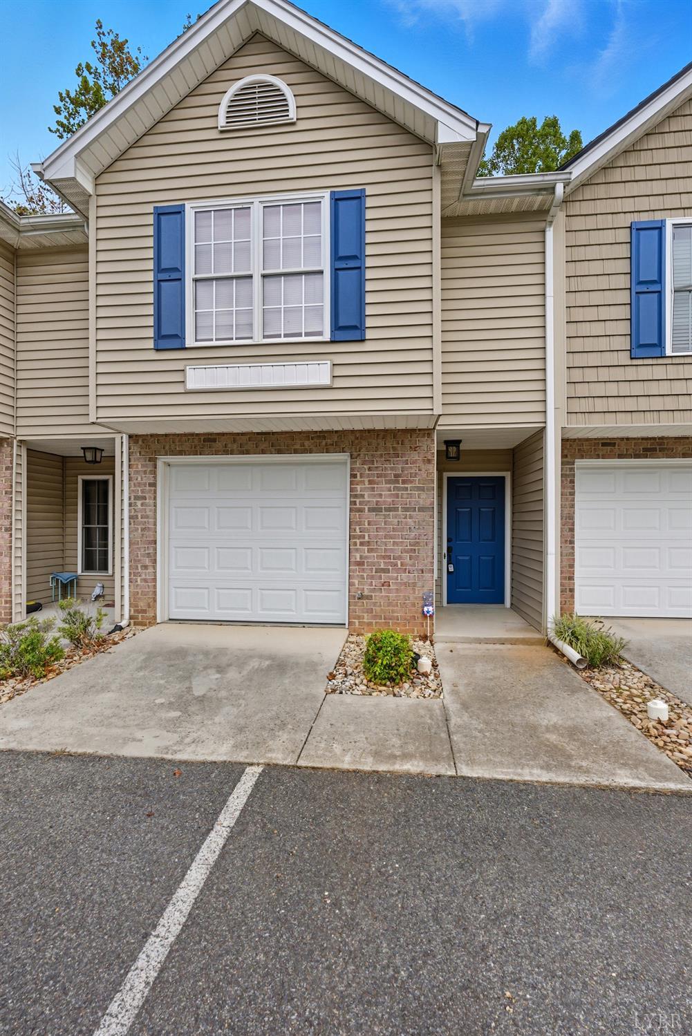 300 McConville Road, Unit 63 Lynchburg, VA 24502 - Photo 25 of 37 a front view of a house with a yard and garage