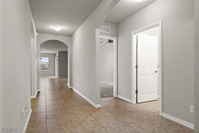 a view of an empty room with a ceiling fan