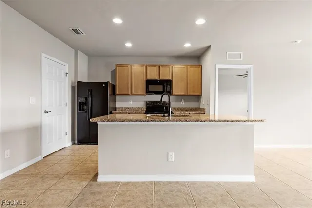 a kitchen with granite countertop a sink and cabinets