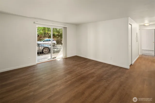 a view of a livingroom with wooden floor and a couch