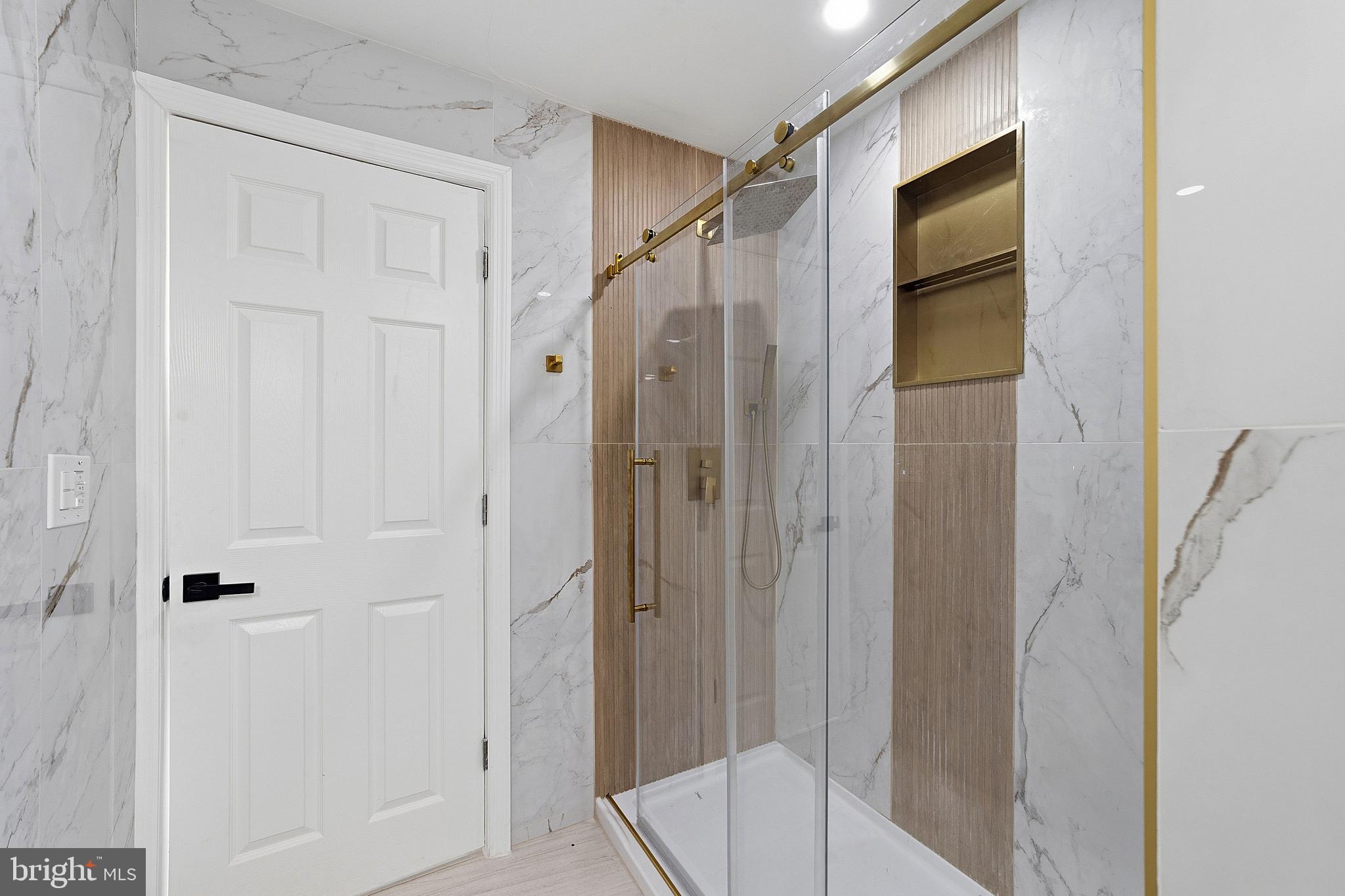523 Front Street Palmyra, NJ 08065 - Photo 5 of 30 a bathroom with a shower and a glass door