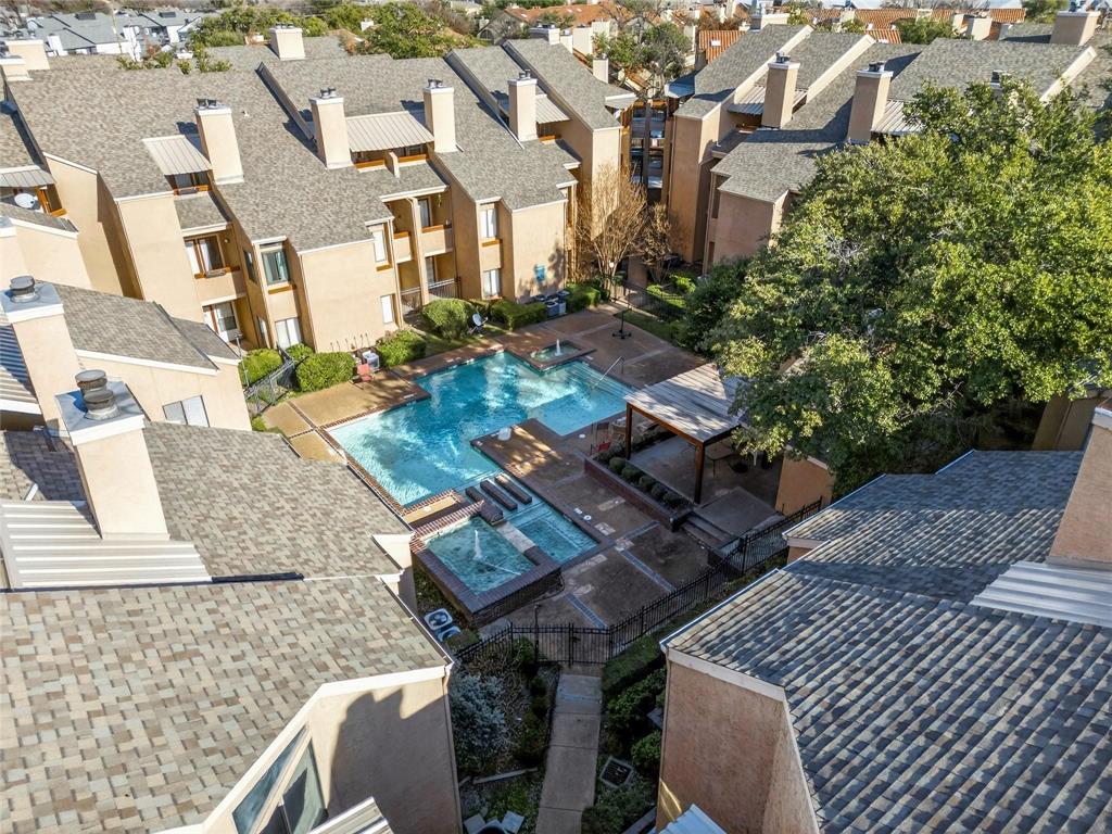 5550 Spring Valley Road, Unit E22 Dallas, TX 75254 - Photo 14 of 14 an aerial view of residential houses with outdoor space