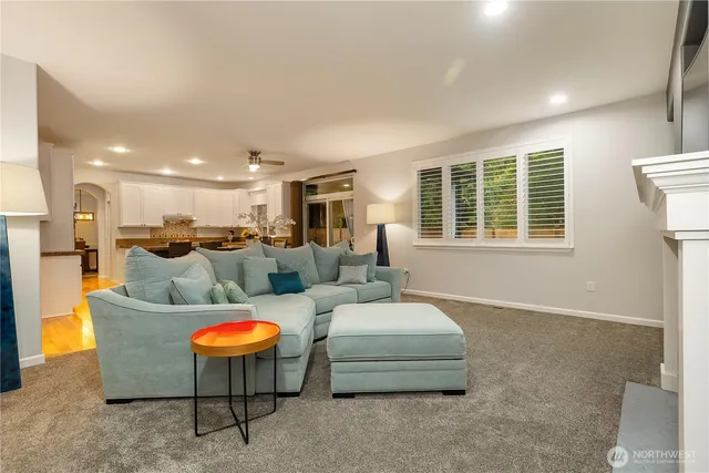 a spacious bedroom with a large bed and a flat tv screen