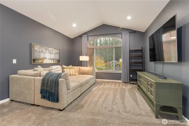 a spacious bedroom with a bed and a chandelier