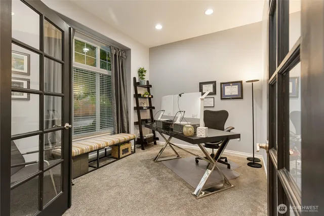 a view of a workspace with furniture and a window