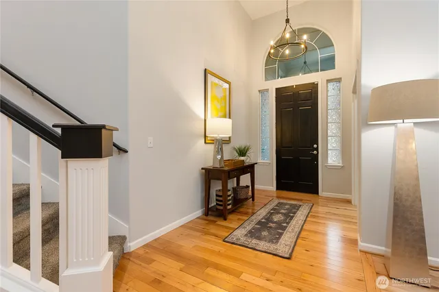 a view of a hallway to a livingroom with furniture