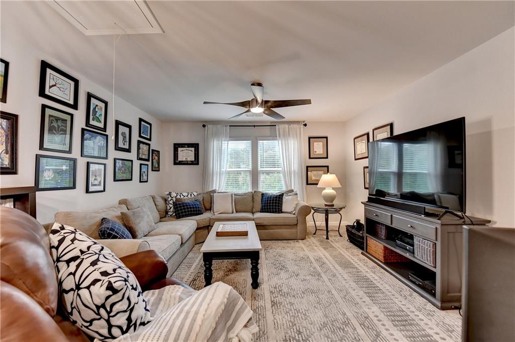 3153 Lowell Road Bethlehem, GA 30620 - Photo 14 of 25 a living room with furniture flat screen tv and a large window