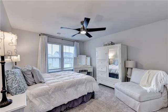 a bedroom with a bed and ceiling fan