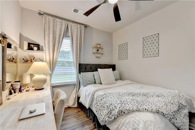 a large bed sitting in a bedroom next to a window