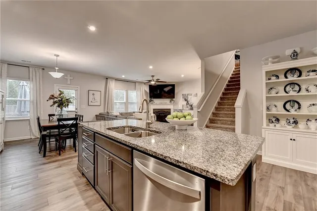 a kitchen with granite countertop a sink a counter top space and appliances
