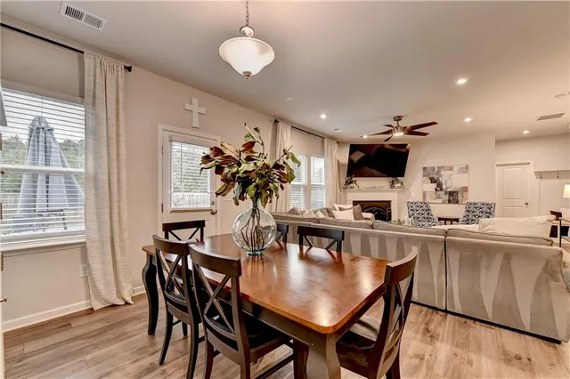 a kitchen with a dining table chairs and microwave