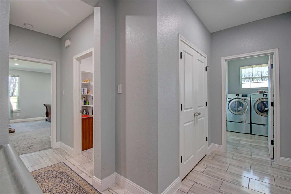 8789 Hutcheson Hill Road Springtown, TX 76082 - Photo 20 of 29 Mud featuring tiled floors and washing machine and dryer