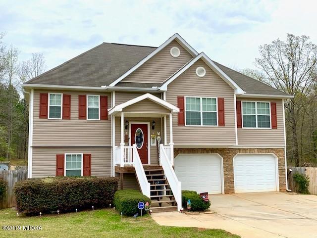3315 Trotters Ridge Trail Gray, GA 31032 - Photo 1 of 33 a front view of a house with a yard and garage