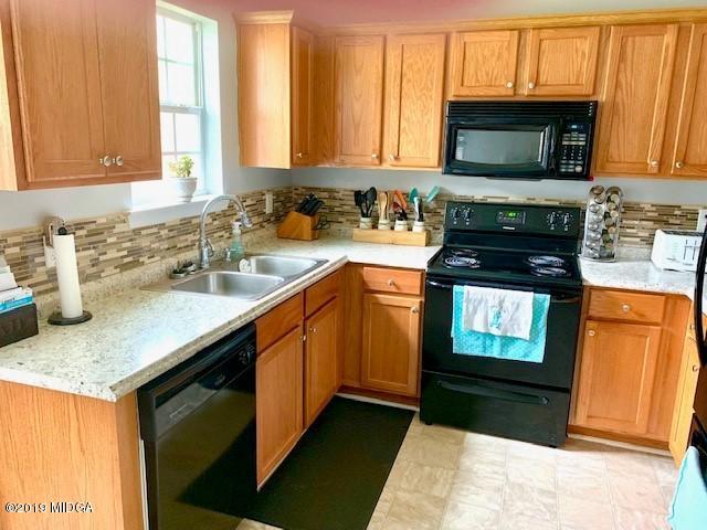 3315 Trotters Ridge Trail Gray, GA 31032 - Photo 2 of 33 a kitchen with stainless steel appliances granite countertop a sink stove and microwave