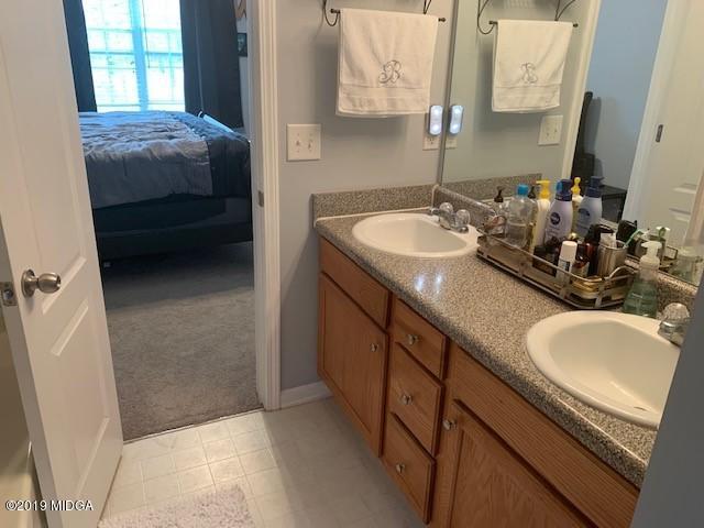 3315 Trotters Ridge Trail Gray, GA 31032 - Photo 18 of 33 a en suite bathroom with a granite countertop sink and a mirror