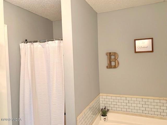 3315 Trotters Ridge Trail Gray, GA 31032 - Photo 19 of 33 a bathroom with a bathtub and shower