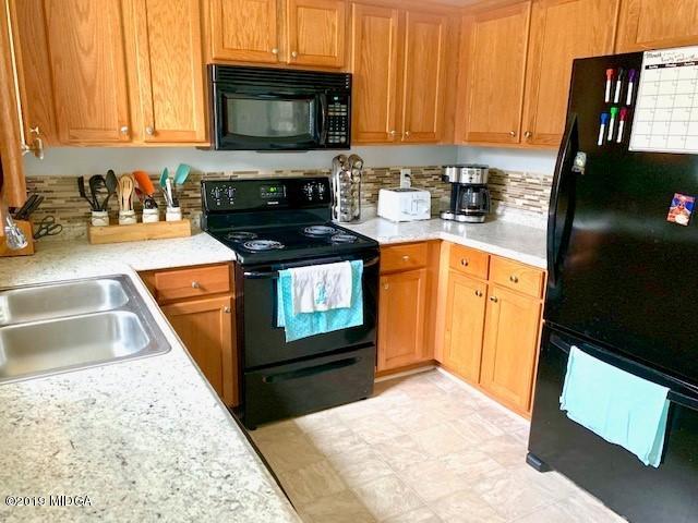 3315 Trotters Ridge Trail Gray, GA 31032 - Photo 3 of 33 a kitchen with a stove a sink and a microwave