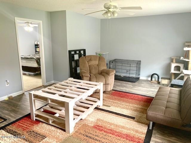 3315 Trotters Ridge Trail Gray, GA 31032 - Photo 22 of 33 a living room with furniture and wooden floor