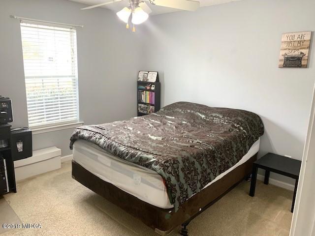 3315 Trotters Ridge Trail Gray, GA 31032 - Photo 24 of 33 a bed sitting in a bedroom next to a window