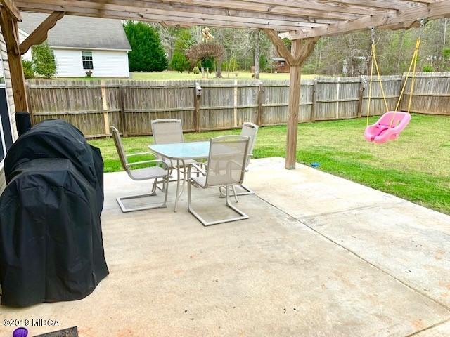 3315 Trotters Ridge Trail Gray, GA 31032 - Photo 26 of 33 a view of a deck with a chair and table in the patio