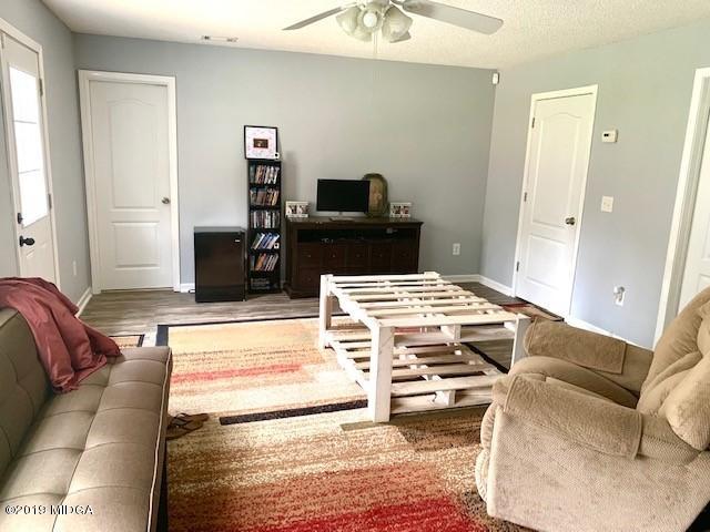 3315 Trotters Ridge Trail Gray, GA 31032 - Photo 32 of 33 a living room with a bed and a flat screen tv