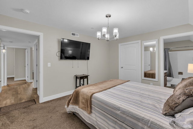 905 South Main Street, Unit G Layton, UT 84041 - Photo 17 of 36 Carpeted bedroom featuring a chandelier and connected bathroom