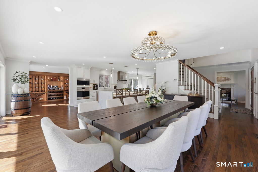 21 Split Rock Road Newtown, CT 06470 - Photo 11 of 40 a dining room with wooden floor a chandelier a wooden table and chairs