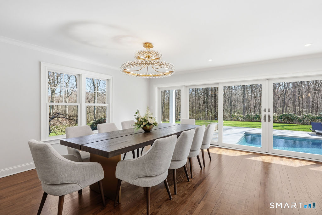 21 Split Rock Road Newtown, CT 06470 - Photo 14 of 40 a view of a dining room with furniture large windows and wooden floor