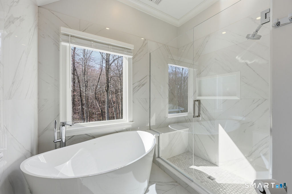 21 Split Rock Road Newtown, CT 06470 - Photo 17 of 40 a bathroom with a tub a sink and a large mirror
