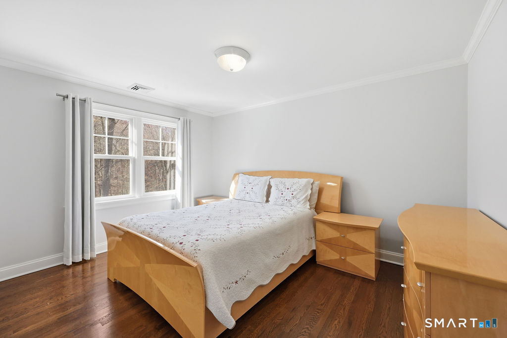 21 Split Rock Road Newtown, CT 06470 - Photo 18 of 40 a bedroom with a bed and wooden floor