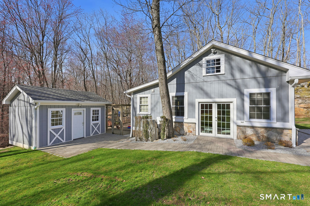 21 Split Rock Road Newtown, CT 06470 - Photo 37 of 40 a front view of a house with a yard and seating space