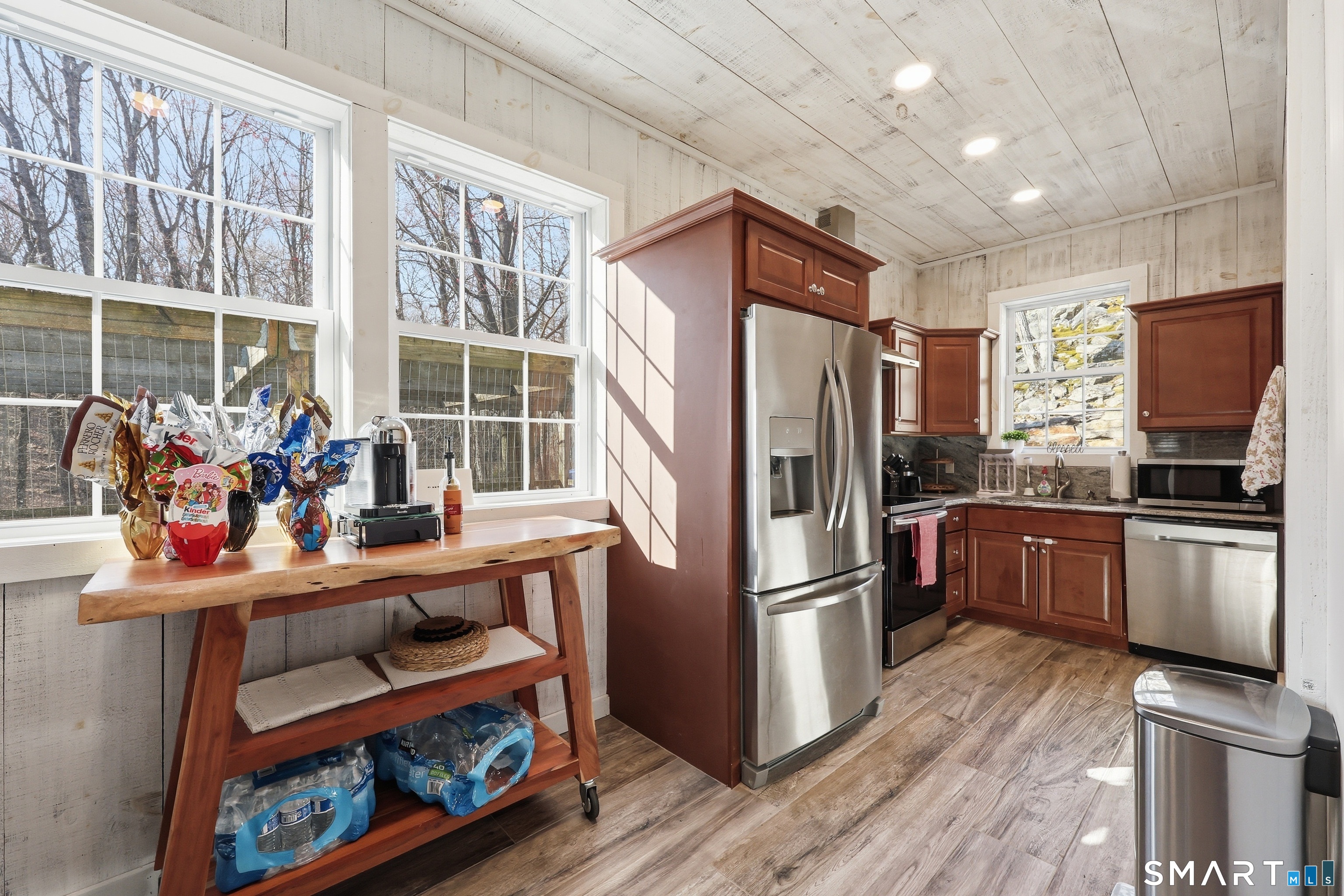 21 Split Rock Road Newtown, CT 06470 - Photo 39 of 40 a kitchen with a refrigerator wooden floor and a window