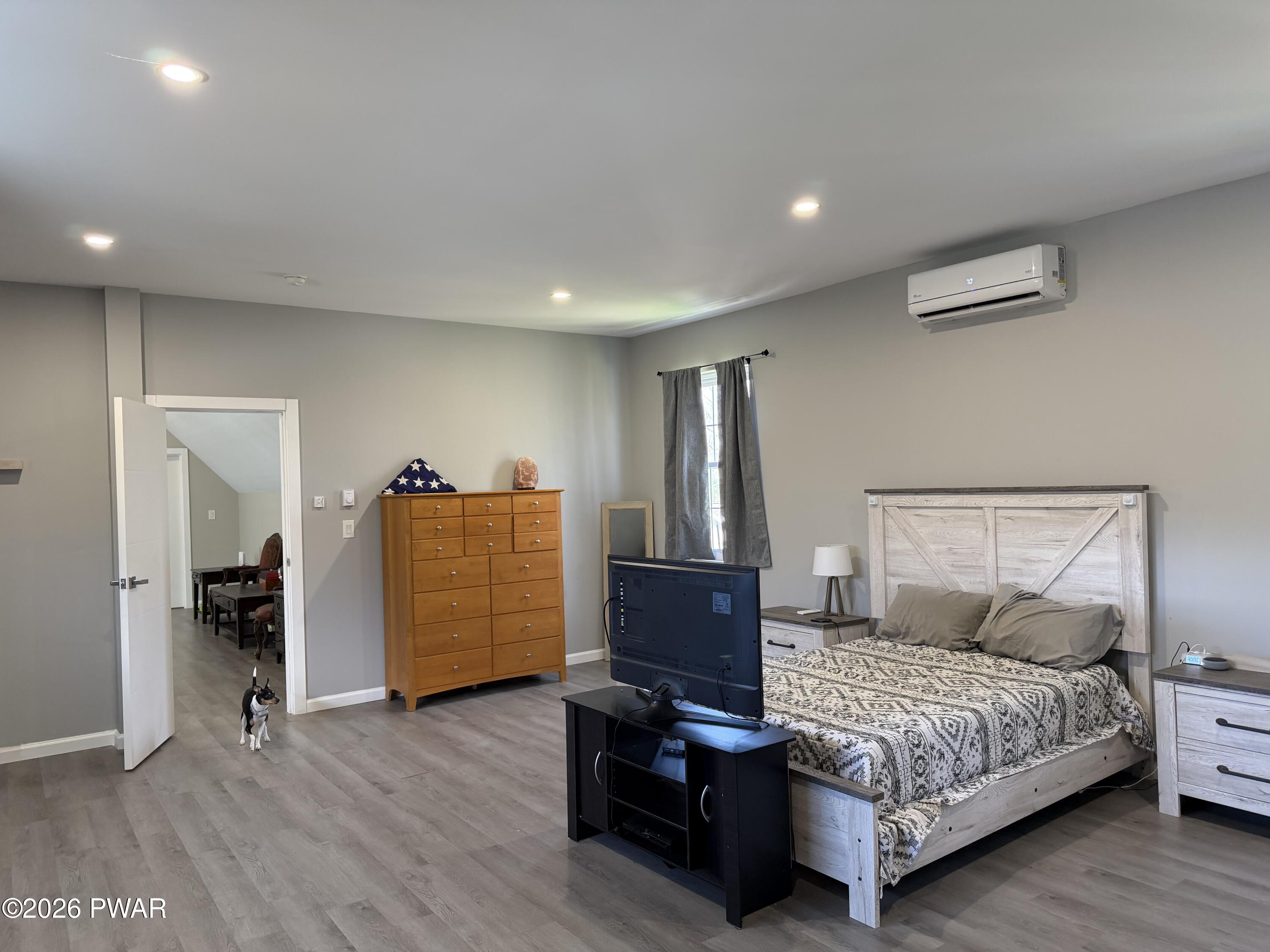 801 Maple Ridge Court Hawley, PA 18428 - Photo 49 of 55 a bedroom with a bed and wooden floor