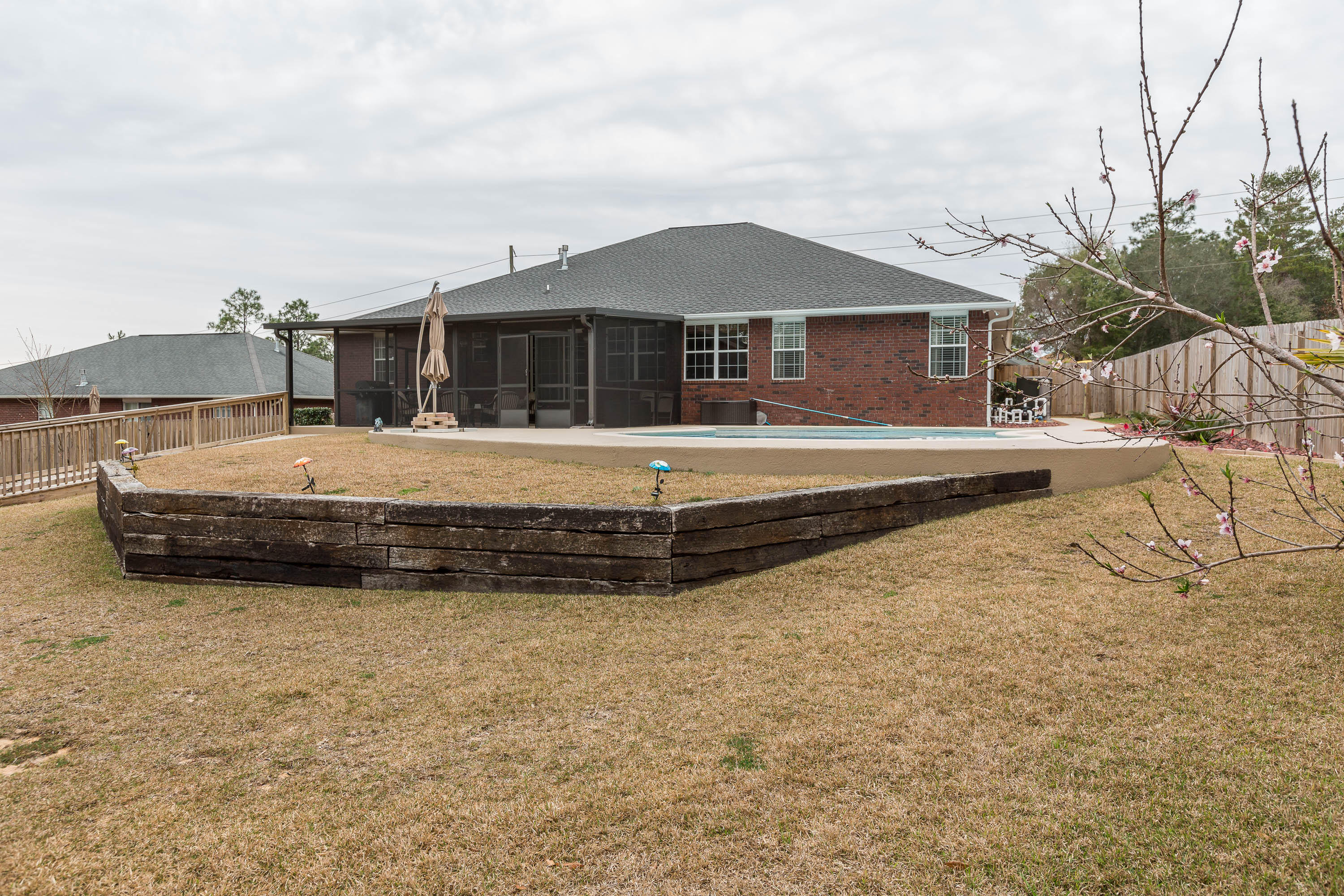 402 Swift Fox Run Crestview, FL 32536 - Photo 15 of 47 a view of a house with a yard and table and chairs under an umbrella