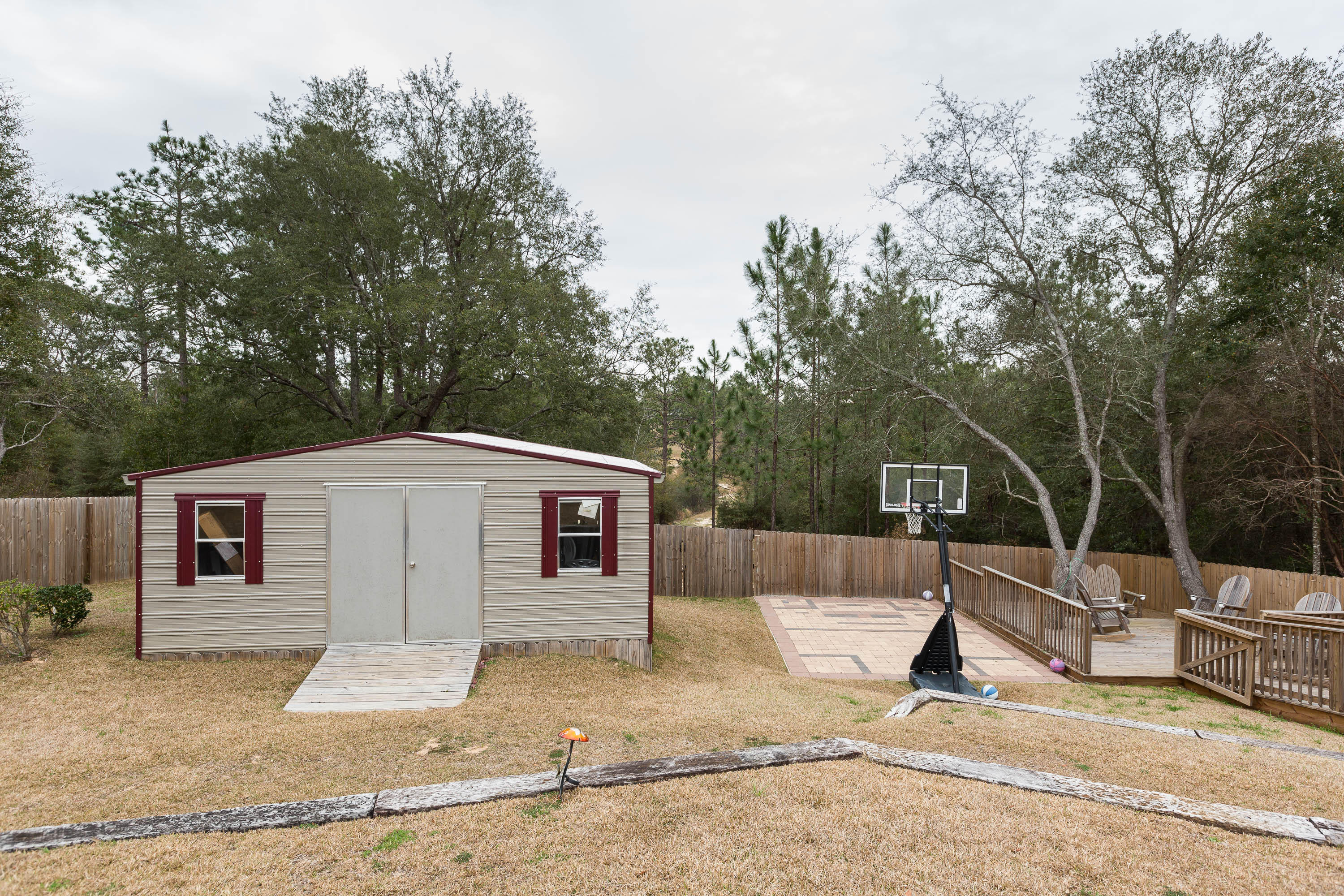 402 Swift Fox Run Crestview, FL 32536 - Photo 16 of 47 a view of a backyard with a tree
