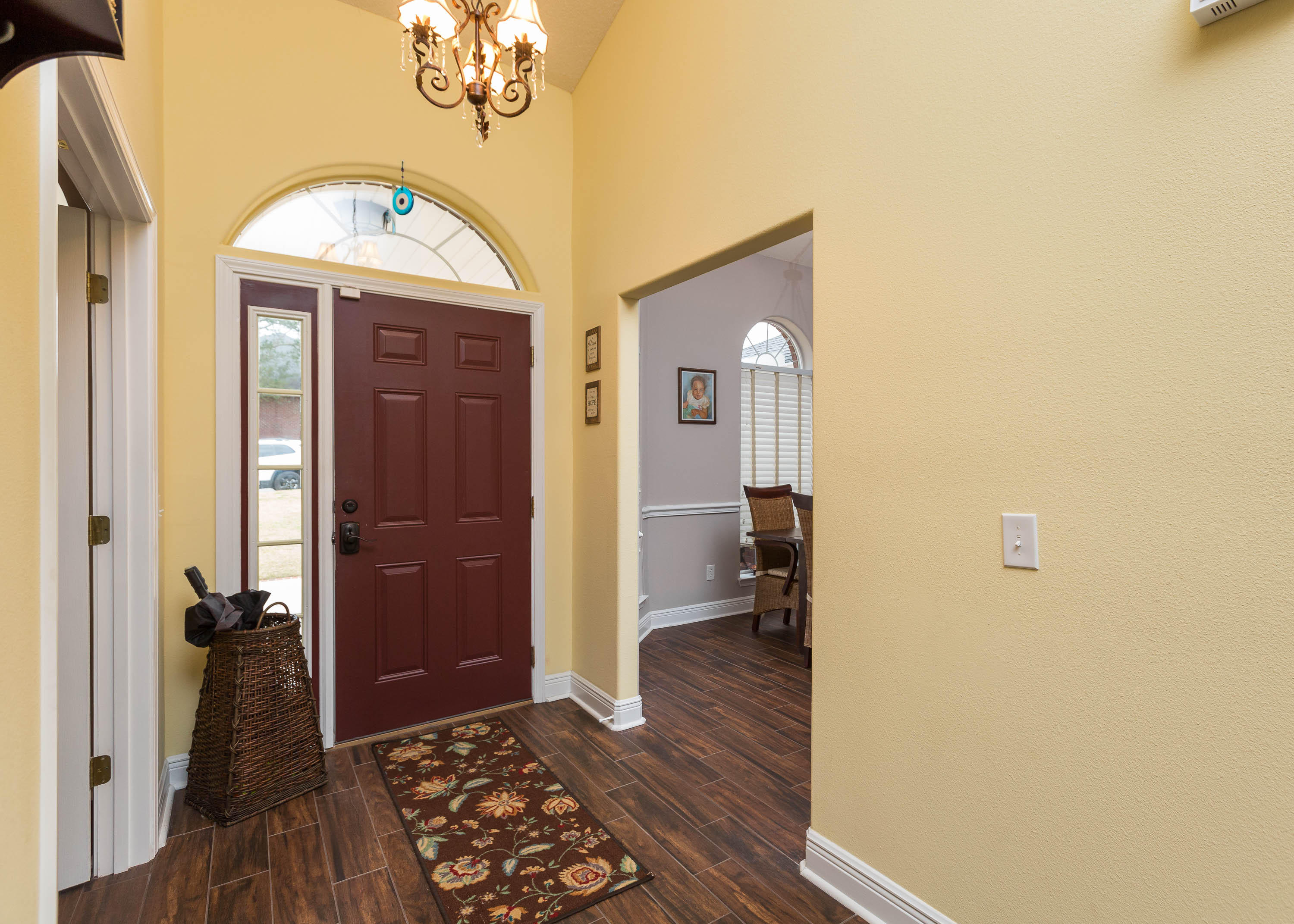 402 Swift Fox Run Crestview, FL 32536 - Photo 17 of 47 a view of a hallway with wooden floor and a livingroom