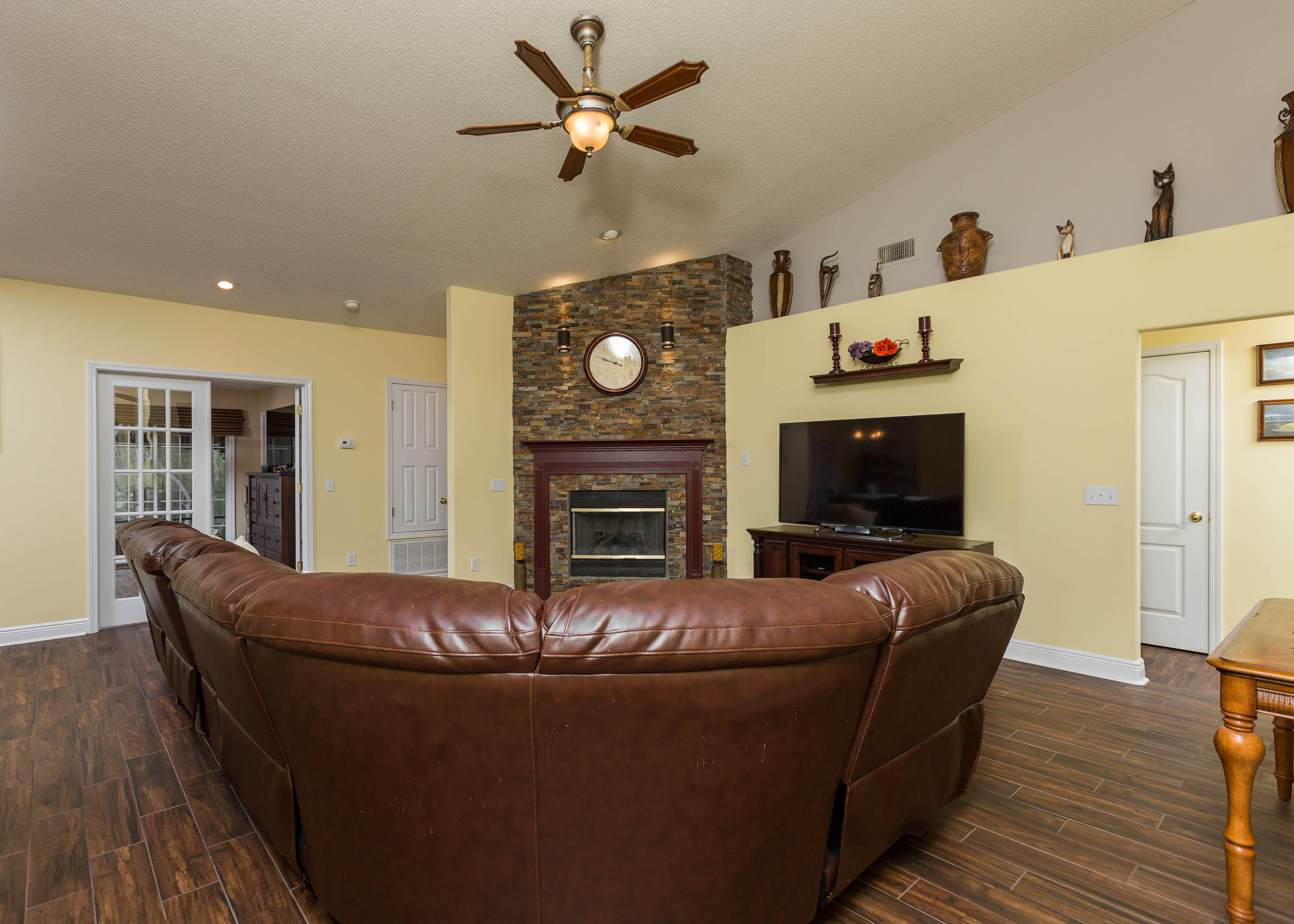 402 Swift Fox Run Crestview, FL 32536 - Photo 23 of 47 a living room with furniture a fireplace and a flat screen tv