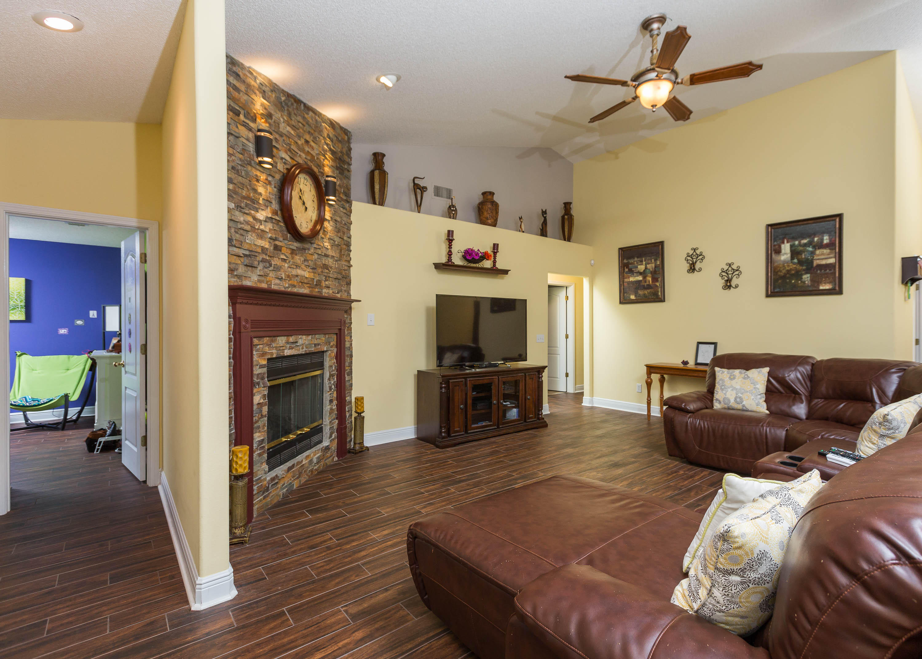 402 Swift Fox Run Crestview, FL 32536 - Photo 24 of 47 a living room with furniture a fireplace and a flat screen tv
