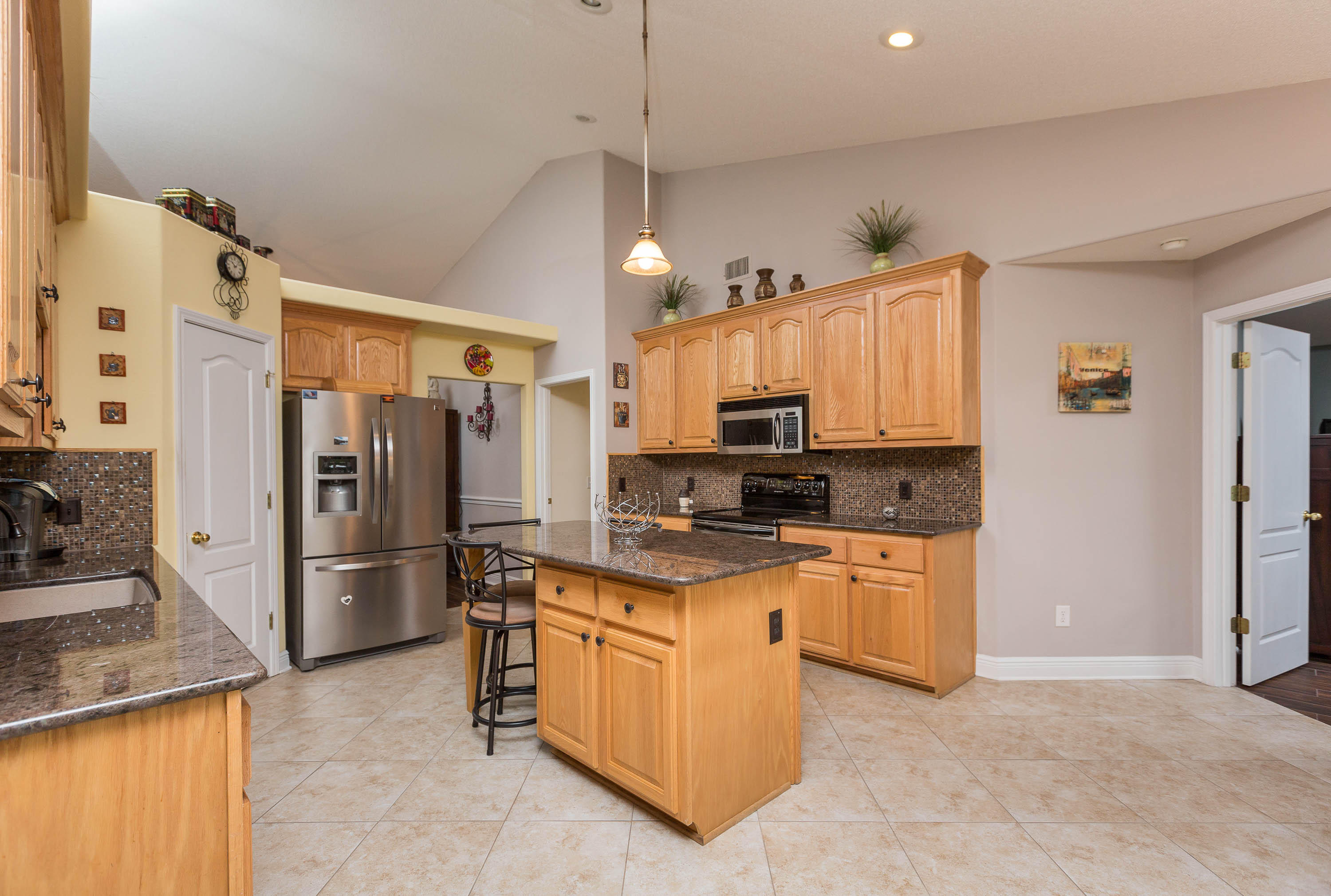402 Swift Fox Run Crestview, FL 32536 - Photo 27 of 47 a kitchen with stainless steel appliances granite countertop a refrigerator a stove top oven a sink and dishwasher