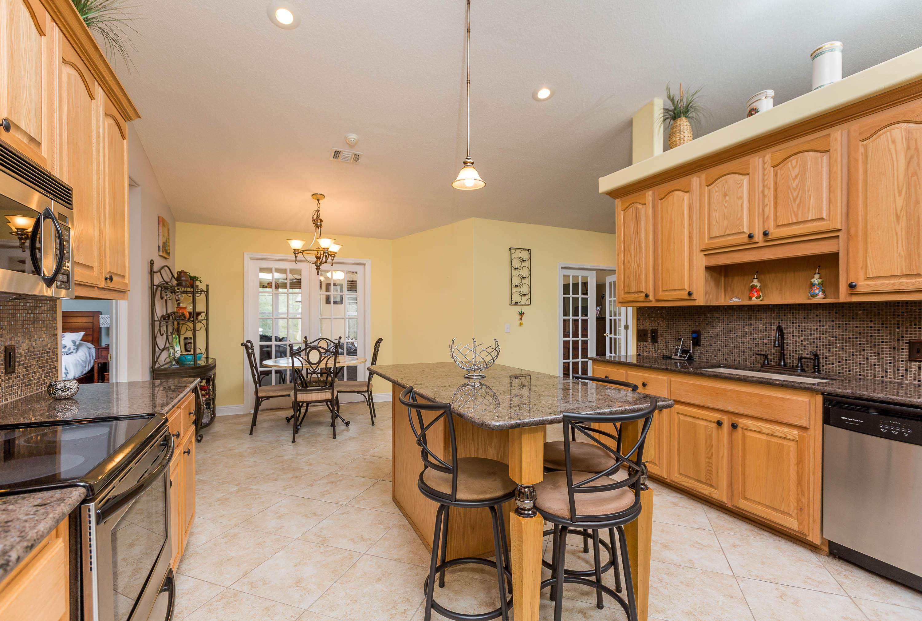 402 Swift Fox Run Crestview, FL 32536 - Photo 29 of 47 a kitchen with granite countertop lots of counter top space dining table and stainless steel appliances