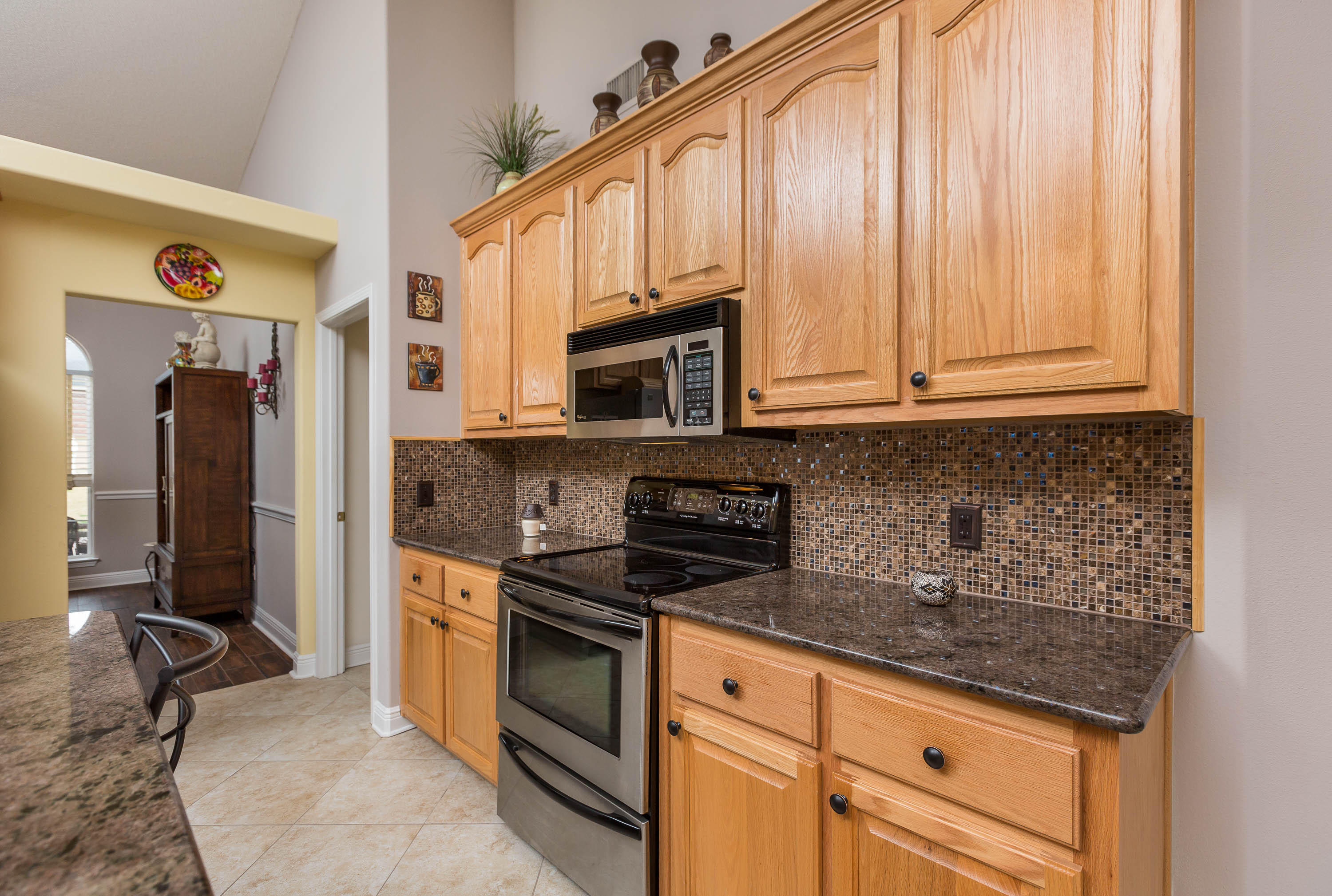 402 Swift Fox Run Crestview, FL 32536 - Photo 30 of 47 a kitchen with stainless steel appliances granite countertop a stove a sink and a microwave