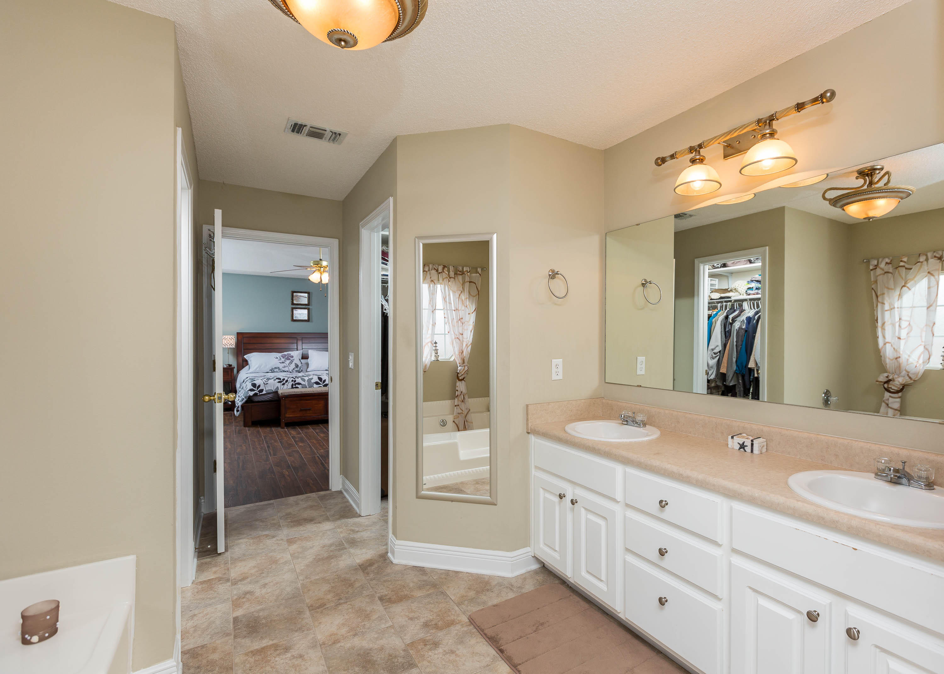 402 Swift Fox Run Crestview, FL 32536 - Photo 34 of 47 a en suite bathroom with double sink and a mirror