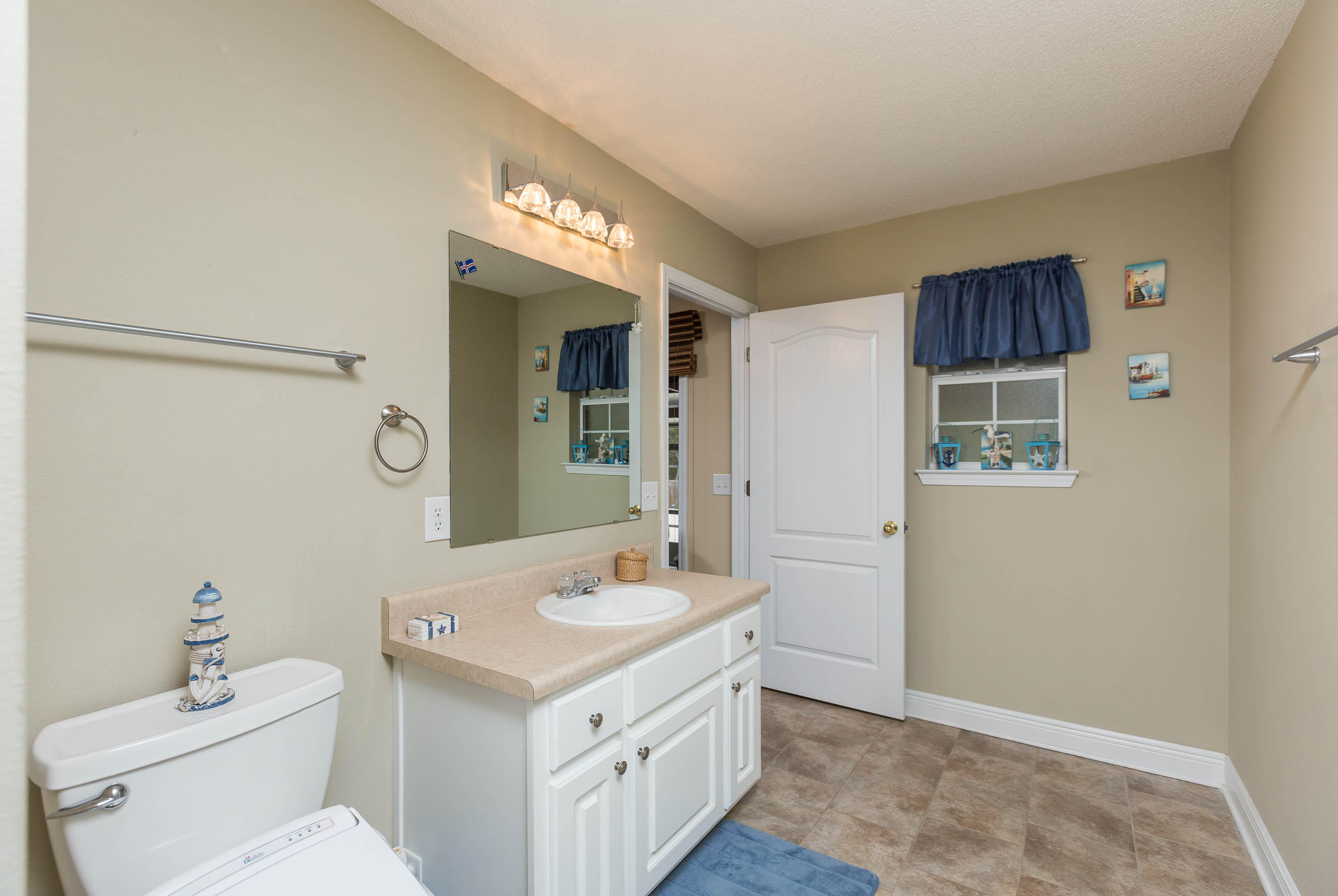 402 Swift Fox Run Crestview, FL 32536 - Photo 41 of 47 a bathroom with a sink a toilet and mirror