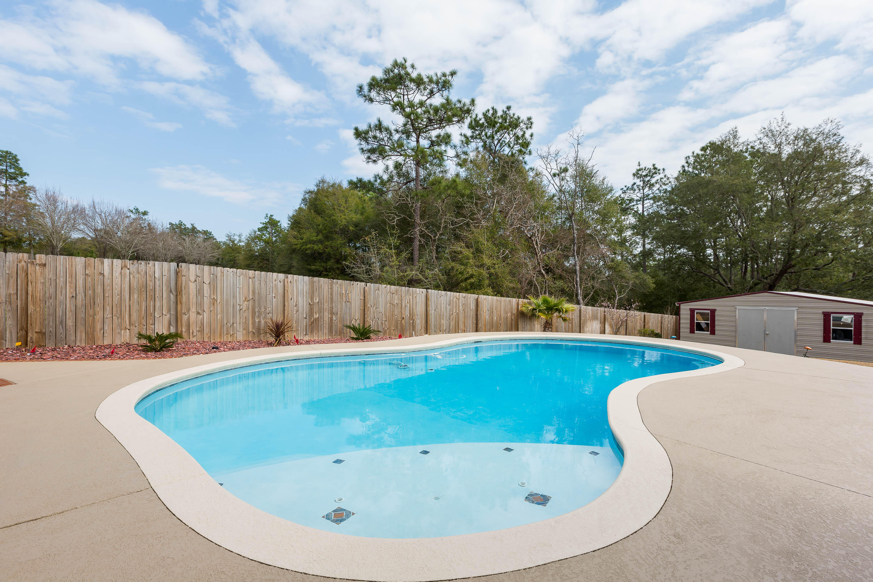 402 Swift Fox Run Crestview, FL 32536 - Photo 8 of 47 a view of a swimming pool and a yard