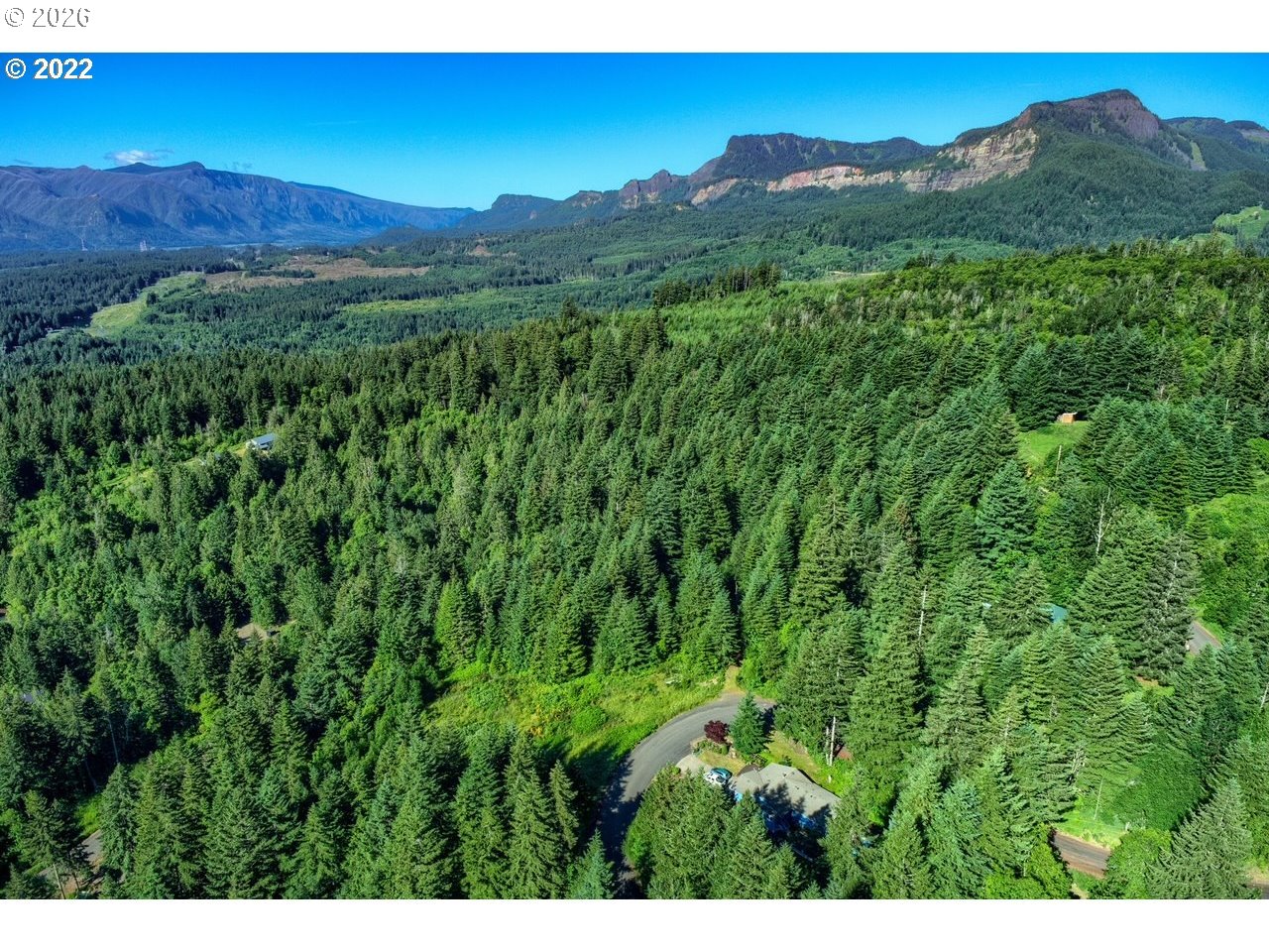 281 Stewart Road Stevenson, WA 98648 - Photo 6 of 6 a view of a lush green hillside and a building