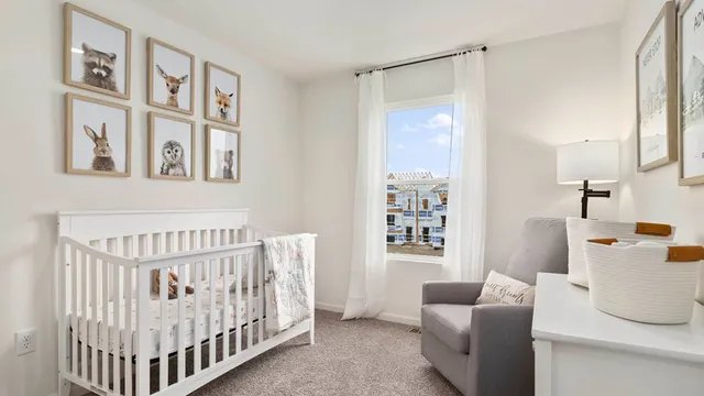 a bedroom with furniture and baby crib
